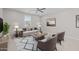 Cozy living room with neutral furniture, ceiling fan, and a view from a bright window at 13473 N 158Th Ave, Surprise, AZ 85379