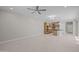 Spacious open living space with modern kitchen, dining area and a ceiling fan at 13473 N 158Th Ave, Surprise, AZ 85379