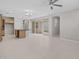 Open living space with tile floors, ceiling fan, island and sliding glass doors at 13473 N 158Th Ave, Surprise, AZ 85379
