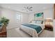 A well-lit primary bedroom with a ceiling fan, large window and artwork at 13473 N 158Th Ave, Surprise, AZ 85379