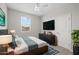 Bright bedroom features a mounted television, a ceiling fan, lots of natural light, and plush carpet at 13473 N 158Th Ave, Surprise, AZ 85379
