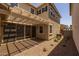 Charming outdoor patio with a pergola, perfect for relaxing or entertaining in the backyard at 13473 N 158Th Ave, Surprise, AZ 85379
