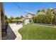 Spacious backyard featuring lush green lawn, a swimming pool, and mature landscaping for privacy at 14545 N 99Th St, Scottsdale, AZ 85260