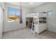 Bright bedroom with a loft bed, desk area, hanging chair and large windows showing mountain views at 14545 N 99Th St, Scottsdale, AZ 85260