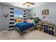 bedroom with blue accents, a basketball hoop, a window view, and playful decorations at 14545 N 99Th St, Scottsdale, AZ 85260