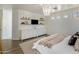 Bright bedroom with white walls, wood floors, and a comfortable bed, dressers and shelves with decorations at 14545 N 99Th St, Scottsdale, AZ 85260
