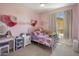 Pink bedroom features decorative accents, a vanity, and natural light from the exterior window at 14545 N 99Th St, Scottsdale, AZ 85260