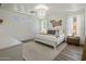 Bright bedroom with white walls, wood floors, a decorative chandelier, and a comfortable bed with stylish pillows at 14545 N 99Th St, Scottsdale, AZ 85260
