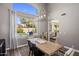 Dining room with modern table and large window overlooking the pool at 14545 N 99Th St, Scottsdale, AZ 85260