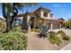 Beautiful home with desert landscaping, three-car garage, and a neutral-toned exterior at 14545 N 99Th St, Scottsdale, AZ 85260