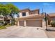 Beautiful two-story home features a private three-car garage, a basketball hoop and desert landscaping at 14545 N 99Th St, Scottsdale, AZ 85260
