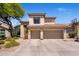 Stunning two-story home featuring a private three-car garage, a basketball hoop and desert landscaping at 14545 N 99Th St, Scottsdale, AZ 85260