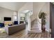 Open-concept living room with wood floors, lots of light, and staircase at 14545 N 99Th St, Scottsdale, AZ 85260