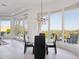 Bright dining area featuring a glass table, modern chandelier, and large windows with scenic mountain views at 15045 E Sundown Dr, Fountain Hills, AZ 85268