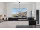 Kitchen featuring white cabinets, black countertops, and stainless steel appliances at 15045 E Sundown Dr, Fountain Hills, AZ 85268