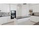 Kitchen featuring white cabinets, black countertops and black appliances, with an island at 15045 E Sundown Dr, Fountain Hills, AZ 85268