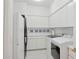 Well-lit laundry room features a modern washer and dryer, white cabinetry and decor, and clean tile floors at 15045 E Sundown Dr, Fountain Hills, AZ 85268