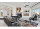 Bright living room with a fireplace, comfortable furniture, large windows, and decorative art at 15045 E Sundown Dr, Fountain Hills, AZ 85268