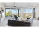 Bright living room featuring large windows with views, comfortable furniture and a ceiling fan at 15045 E Sundown Dr, Fountain Hills, AZ 85268