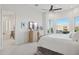 Serene main bedroom featuring a dresser with a TV, access to the bathroom, and bright windows at 15045 E Sundown Dr, Fountain Hills, AZ 85268