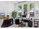 Well-lit home office with black desk, three windows with mountain views, and a modern TV at 15045 E Sundown Dr, Fountain Hills, AZ 85268