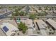 Aerial view of a neighborhood highlighting backyard pool, solar panels, street, and the surrounding community at 1518 E 12Th St, Casa Grande, AZ 85122