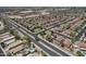 Overhead view of a neighborhood with swimming pools and tree-lined streets, surrounded by desert landscape at 1518 E 12Th St, Casa Grande, AZ 85122
