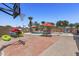 Spacious brick patio featuring a basketball court, inground pool, umbrellas, and room to relax with chairs and kayaks at 1518 E 12Th St, Casa Grande, AZ 85122