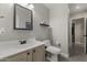 A well-lit half bathroom features a decorative mirror and neutral walls at 1518 E 12Th St, Casa Grande, AZ 85122