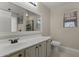 A well-lit bathroom features a large mirror, and a tiled walk-in shower at 1518 E 12Th St, Casa Grande, AZ 85122