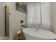 Modern bathroom featuring a standalone tub, a shower with glass doors and stylish fixtures at 1518 E 12Th St, Casa Grande, AZ 85122