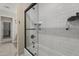 Modern bathroom featuring sleek white subway tiles and a glass shower door at 1518 E 12Th St, Casa Grande, AZ 85122