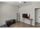 The bedroom features wood floors, a large flat-screen TV, and neutral paint at 1518 E 12Th St, Casa Grande, AZ 85122