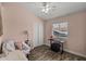 Cozy bedroom with pink walls and a ceiling fan provides a relaxing atmosphere at 1518 E 12Th St, Casa Grande, AZ 85122