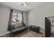This bedroom boasts a cozy futon, wood floors and a ceiling fan for comfort at 1518 E 12Th St, Casa Grande, AZ 85122