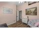 A charming bedroom painted pink features stylish decor and neutral wood flooring at 1518 E 12Th St, Casa Grande, AZ 85122