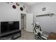 This bedroom boasts a large flat-screen TV and wood look tile floors at 1518 E 12Th St, Casa Grande, AZ 85122