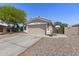 Traditional home with a two-car garage, a well-manicured lawn, and a convenient side gate for easy access at 1518 E 12Th St, Casa Grande, AZ 85122