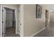 This hallway features access to a well-lit laundry room and neutral decor at 1518 E 12Th St, Casa Grande, AZ 85122
