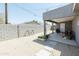 Expansive backyard featuring a covered patio, decorative elements, and low-maintenance gravel landscaping at 1546 W Pierce St, Phoenix, AZ 85007
