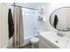 Clean bathroom featuring a shower-tub combo, a modern vanity, and a stylish round mirror at 1546 W Pierce St, Phoenix, AZ 85007