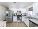 Well-equipped kitchen boasting stainless steel appliances, granite countertops, and ample natural light at 1546 W Pierce St, Phoenix, AZ 85007