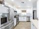 Bright, modern kitchen featuring white cabinets, stainless steel appliances, and granite countertops at 1546 W Pierce St, Phoenix, AZ 85007
