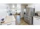 Open kitchen featuring stainless steel appliances and a view into a sun-filled living area at 1546 W Pierce St, Phoenix, AZ 85007