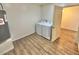 Functional laundry room with new appliances, wood-look tile flooring, and easy access via a classic paneled door at 1546 W Pierce St, Phoenix, AZ 85007