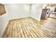 Open-concept living room featuring beautiful wood-look tile and lots of natural light, seamlessly flowing into the kitchen at 1546 W Pierce St, Phoenix, AZ 85007