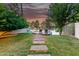 Inviting backyard features a walkway to a deck overlooking the pond at 1591 S Sycamore Pl, Chandler, AZ 85286