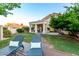An inviting backyard featuring a lush lawn, shaded patio, and comfortable lounge chairs at 1591 S Sycamore Pl, Chandler, AZ 85286