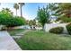 Landscaped backyard features a stone path leading to a deck with pond views at 1591 S Sycamore Pl, Chandler, AZ 85286