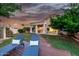 Relaxing backyard with lounge chairs, a covered patio, and lush landscaping at 1591 S Sycamore Pl, Chandler, AZ 85286